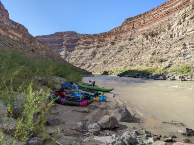 picture of inflatable boats on the shore of a river.