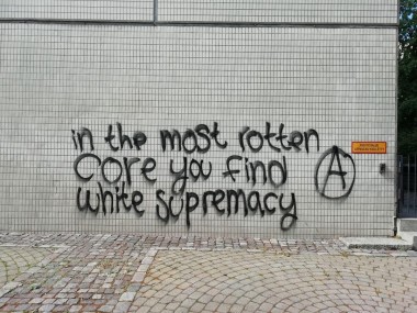 "In the most rotten core you find white supremacy" written on a wall with black spray paint