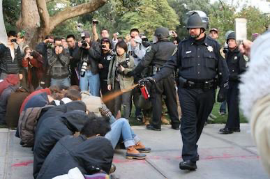 Cop pepper sprays seated demonstrators. 
