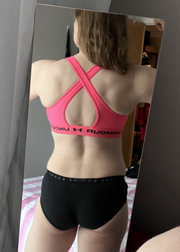 Mirror selfie of me in black Bonds boyleg pants and neon pink Underarmour sports bra. Literally just showing off the muscle definition in my back…though my butt and legs look good too, as always. 