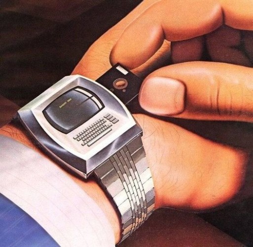 A watch with a computer screen and full, but tiny keyboard is getting some software from a miniaturised 5.25 magnetic floppy. This probably looked really futuristic at some point.