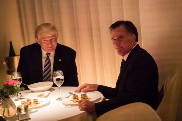 A dinner portrait from hell: Donald Trump grinning demonically as Mitt Romney looks at the camera in abject embarrassment.

And what's that on his plate?!