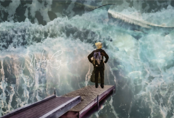 This is a photo montage of a woman wearing a backpack standing at the end of a dock. Ocean waves rise in front of her, fish and a whale can be seen in the water.