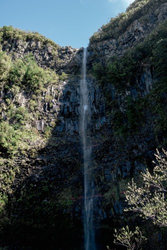 Photo of waterfall, cliffs overgrown with greenery
