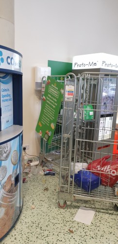 The food bank collection point in Morrisons supermarket at Tewkesbury GL20 showing a pair of trolleys in a rubbish strewn corner of the exit. The food bank sign on the foodbank trolley is half hanging off. The foodbank trolley is adjacent to a pile of detritus on the floor and another trolley stacked with bags of rubbish.
It is a disgrace to Morrisons Supermarkets.