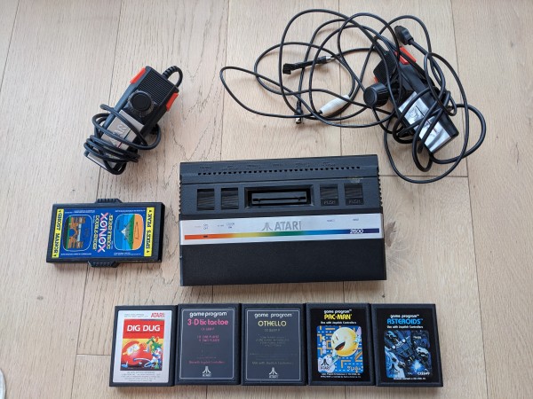 Photo of an Atari 2600 console with peripherals and a few games