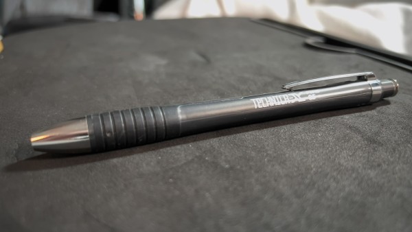 Photo of a dark grey Pentel Technica-X mechanical pencil with the lead pipe retracted.