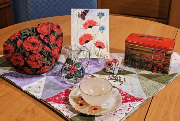 A tea tableau with red poppies and English Breakfast black tea from New English Teas 