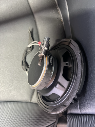 tools stuck to the magnet at the back of a speaker.