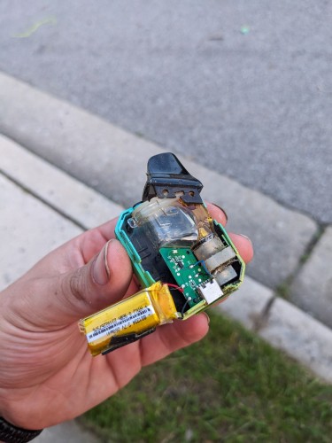 crushed vape box with lithium battery hanging out of it
