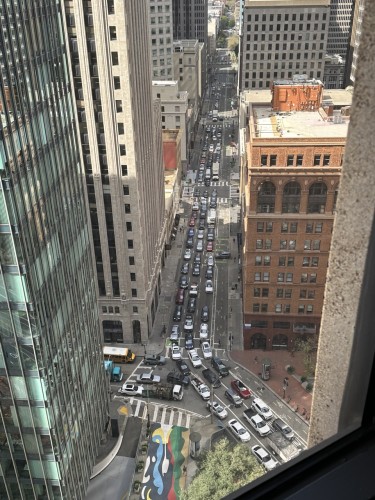 Battery and Bush Streets choked with rush hour traffic, surrounded by skyscrapers 