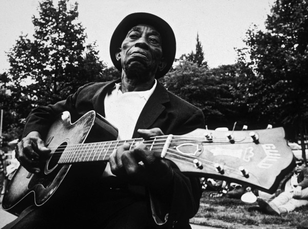 Mississippi John Hurt playing guitar in a park