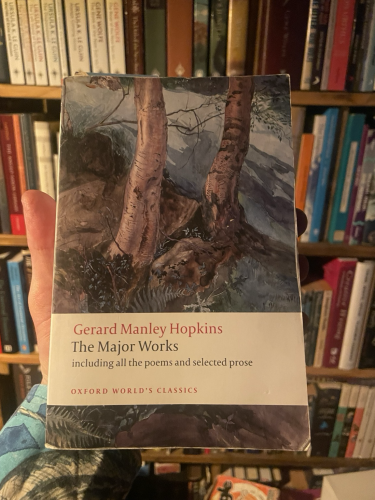 A copy of Gerard Manley Hopkins’s ‘The Major Works’ seen in front of a bookcase 