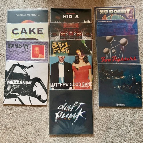 13 vinyl records laid out on the floor. Coldplay, Radiohead, No Doubt, Cake, The Crystal Method, Red Hot Chili Peppers, Ben Folds Five, Reel Big Fish, Foo Fighters, Massive Attack, Matthew Good Band, The Avalanches, and Daft Punk