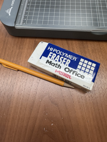 A comically large eraser labeled “math office” and a mechanical pencil that is only a little longer than the eraser. 