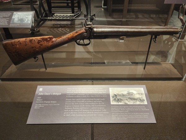 sawed-off shotgun in museum display at the Colorado History Museum