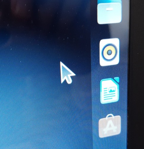 Photo of my laptop screen with the lil cursor arrow thingy beside some desktop icons. The arrow is nearly as big as the icons.