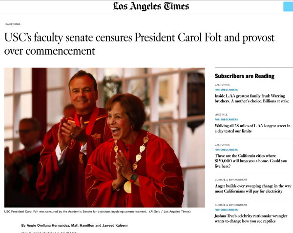 Screen shot of Los Angeles Times, headline reads "USC’s faculty senate censures President Carol Folt and provost over commencement" accompanied by a picture of Folt and Board of Trustees member Rick Caruso in red academic robes looking like grinning red devils