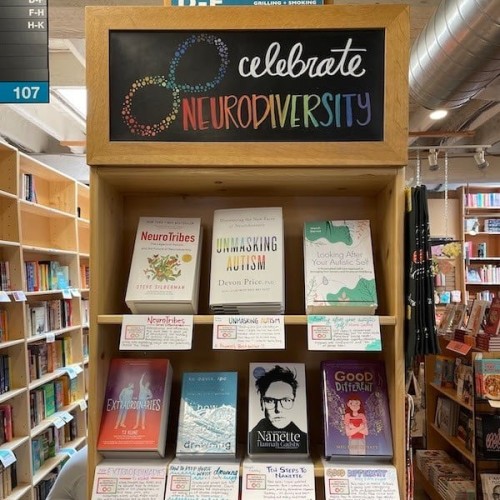 A display of books under the sign "Celebrate Neurodiversity."