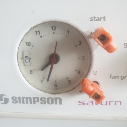 Oven clock with 2 orange plastic wire connectors functioning as control knobs