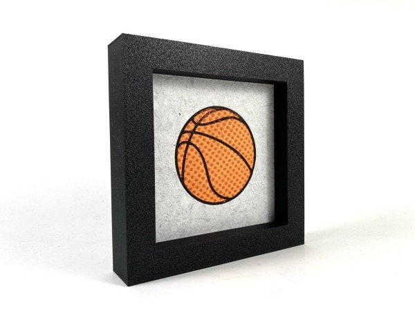 A framed three color relief print of a basketball.