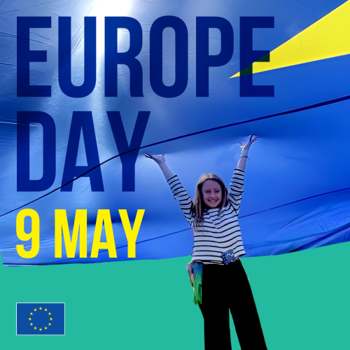 A photo showing a woman standing underneath a canopy of a giant EU flag. The text reads 'Europe Day 9 May' The EU emblem appears in the bottom left corner.