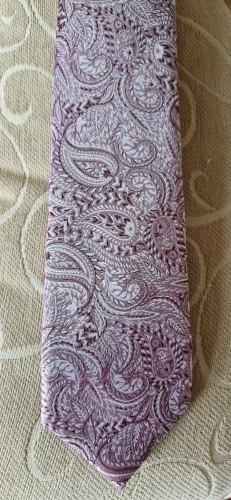 A light and dark pink silk tie with swirling paisley patterns.

(No that's not my shirt in the background, it's the arm of a chair) 😊