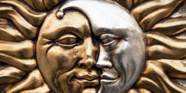 Sculpture of conjoined golden sun and silver moon.