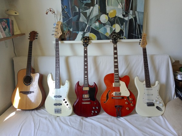 Photo satisfaisante de cinq guitares sur un canapé