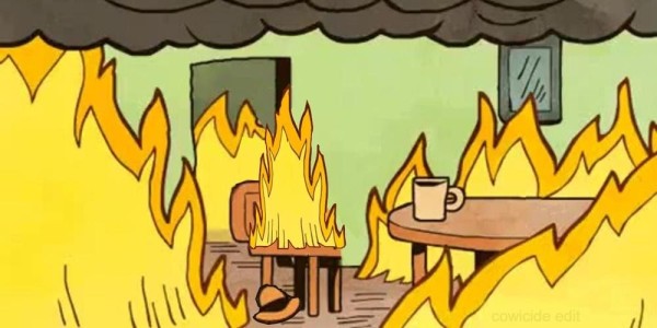 This is fine meme image, but with the dog replaced by flames. Dog's hat lays on the floor.