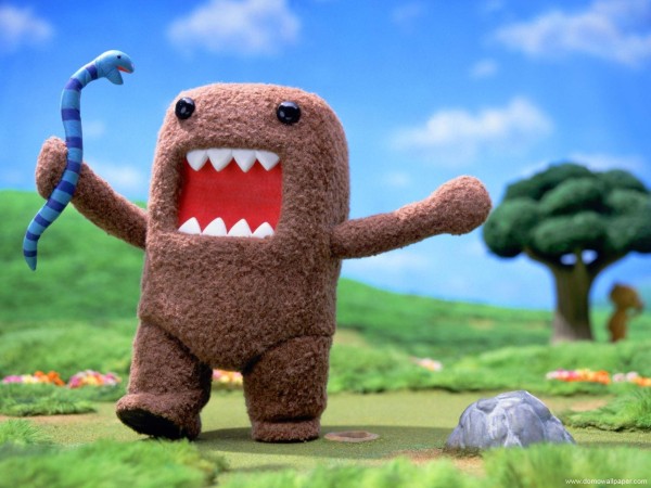cute looking brown monster (Domo), holding a snake, warlking through a green landscape, green grass, a tree in the background, blue sky with some white clouds