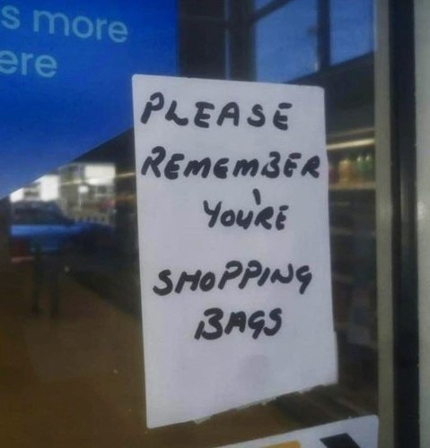 Sign on a glass door: Please remember you're shopping bags