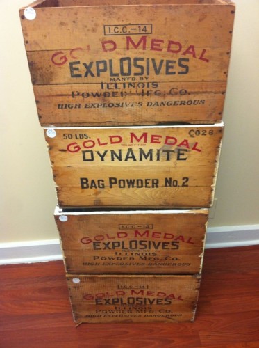 Four wood crates.
Three are labeled "Explosives", one is labeled "Dynamite".