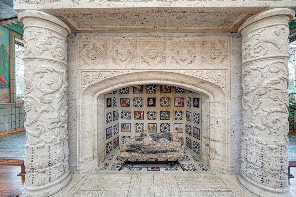 a stone building with a fire place in front of it