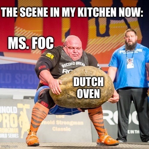 A strongman competitor lifting a large stone, with meme text superimposed, comparing the scene to kitchen activity (Ms. FoC lifting a Dutch oven).