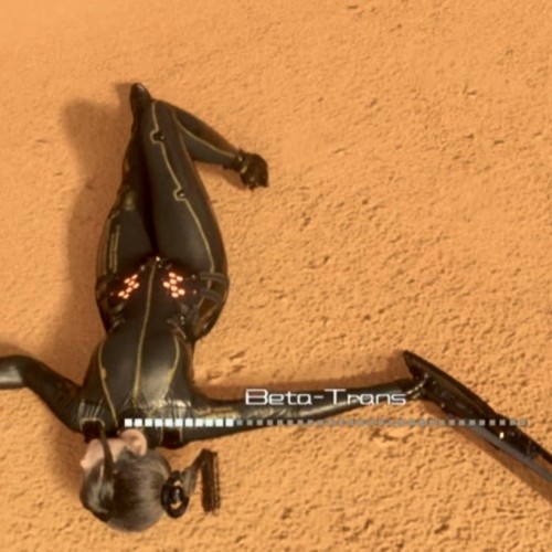 Screenshot from the game. Main character is lying on the ground in a desert. The hud has a meter labeled “Beta-Trans”