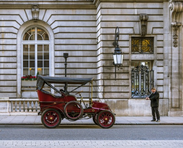Classic antique car parked outside historic building being photographed by passerby, London
Captured by Komeil Karimi