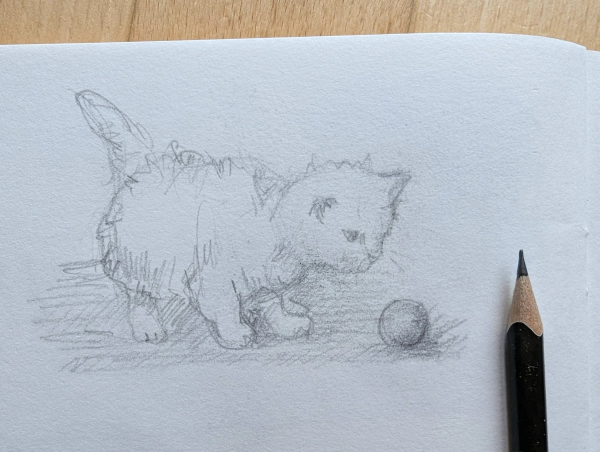 Handmade black and white pencil drawing of a cute little cat with a ball by artist Karen Kaspar