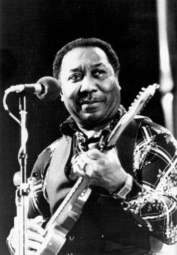Black and white photo of Muddy Waters performing with guitar