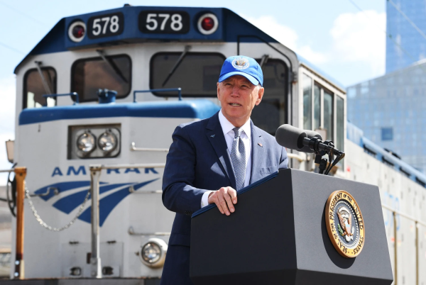 Joe Biden giving a speech in front of an Amtrak Train