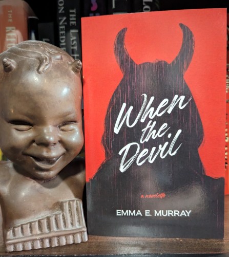 Paperback of WHEN THE DEVIL, a novelette by Emma E. Murray. The cover has the silhouette of a woman with horns in front of a red background