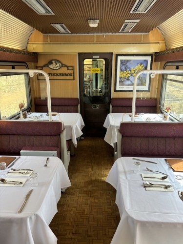Dining car with tables set for lunch.