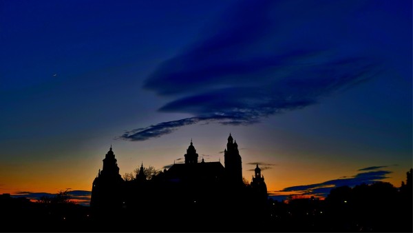 The ornate towers of an Edwardian Baroque museum silhouetted against the sunset.