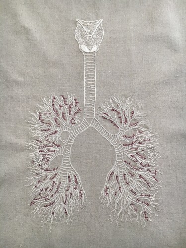 An embroidery on a pale natural linen. There is a bone white diagram of a vocal apparatus, trachea, and bronchi/lungs. In between the branches of the bronchioles are small words embroidered in cursive in thin burgundy thread. They read: she breathed. Inhaled. exhaled. she knew. that breathing. was beauty. was the way. inside. to outside. when her breath. tightened. she found. ways. to soften. be still. to allow that. in. of the out. breath. to be. the. way through. she found the throughline. somehow. it. also found her. still. and   breathing. deeply. each day was. new. each breath. a. different. path. always. through her. and. throughout her. such a. simple. thing, breath. such a journey. through. trees. and. branches. how the body knows. to still. itself. if we learn how. to. listen deeply.