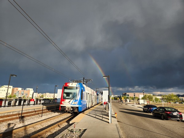 A UTA Trax train underneath a double rainbow. The rainbow points towards Provo, which is decidedly not gay, but we saw a bunch of families with cargo bikes as we biked through there today which was neat.