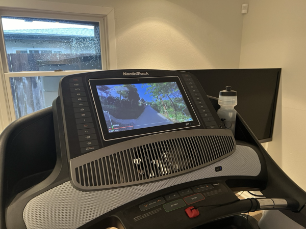 A treadmill with video display. In the display is a POV video of a run in Indonesia