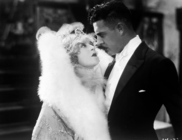 Four pictures of Mae Murray and John Gilbert either embracing or in intimate proximity to each other in the 1925 silent dark romantic dramedy “The Merry Widow”.