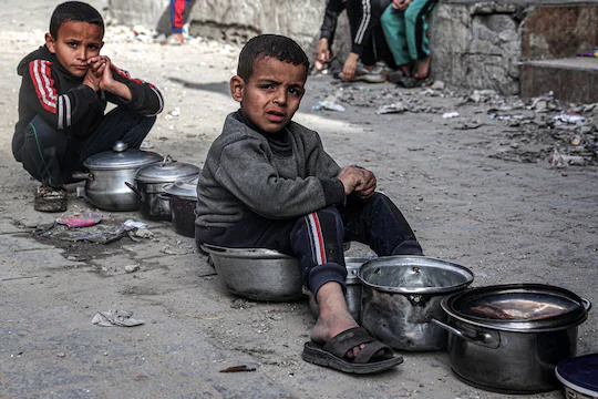 Boys sit with empty pots in Rafah on Saturday as displaced Palestinians line up for meals provided by a charity organization ahead of the fast-breaking iftar meal during the Muslim holy month of Ramadan. 

Photo: Said Khatib/AFP/Getty Images