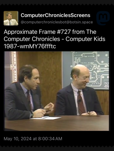 An image from the Computer Chronicles episode titled Computer Kids. The focus is two old dudes in suits looking to one side. 