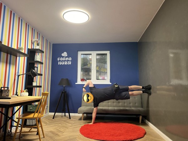 Me doing plank using one arm while my feet are on the wall